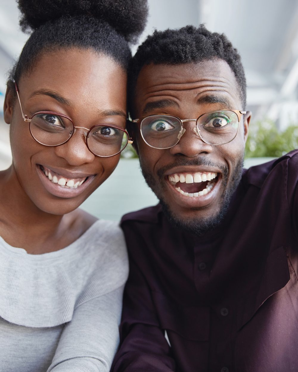 Joyful young Black man and woman taking a selfie together